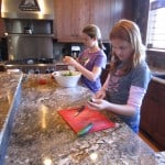 Megan is using a fork to make the cucumber pretty!