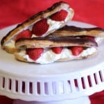 Strawberry and whipped cream filled chocolate eclairs