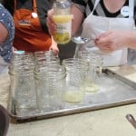 Filling jars with lemon juice for the tomatoes