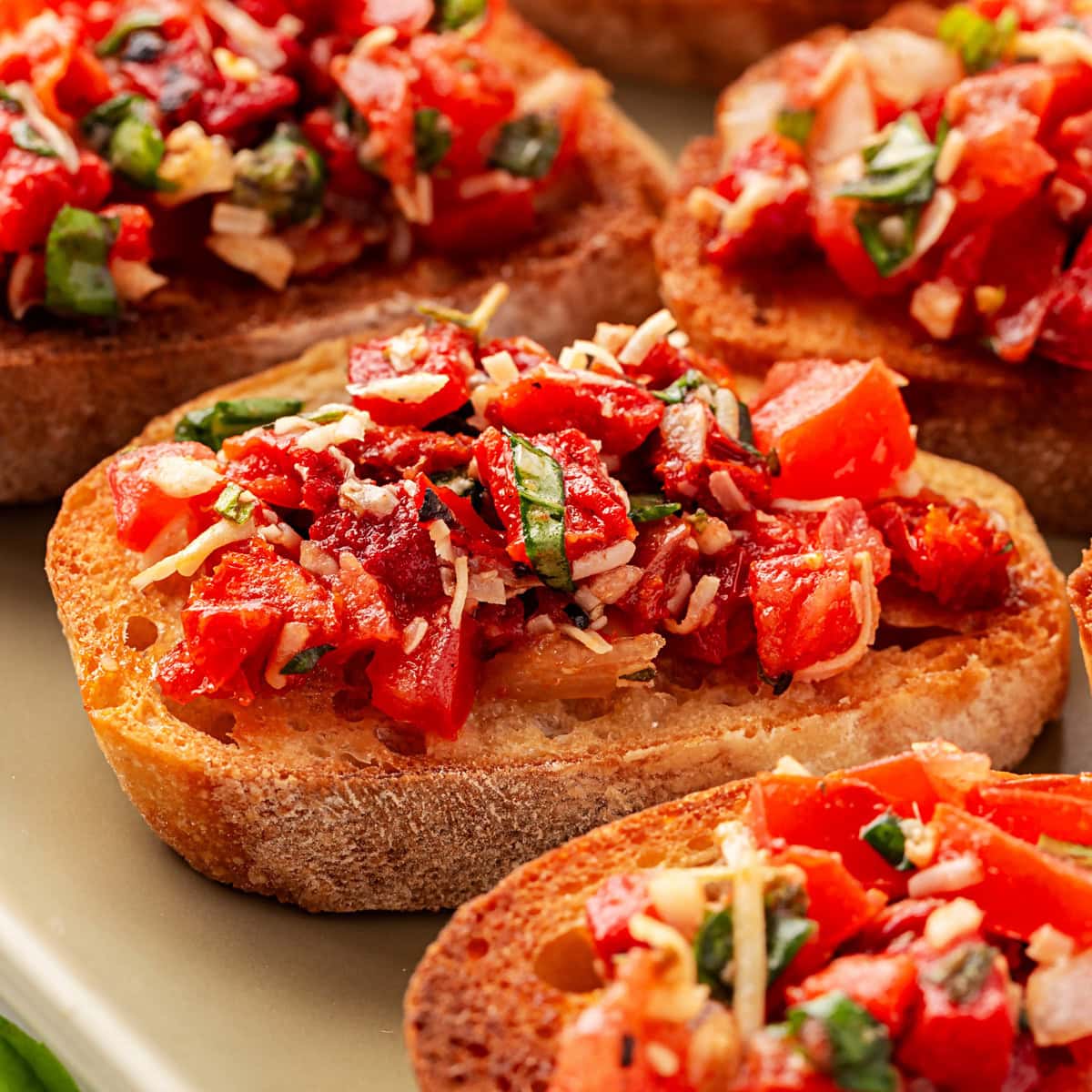 This Best Tomato Bruschetta recipe will have you making it all year round. The flavors are perfectly balanced and one that I get rave reviews from. Close-up of Tomato Bruschetta.