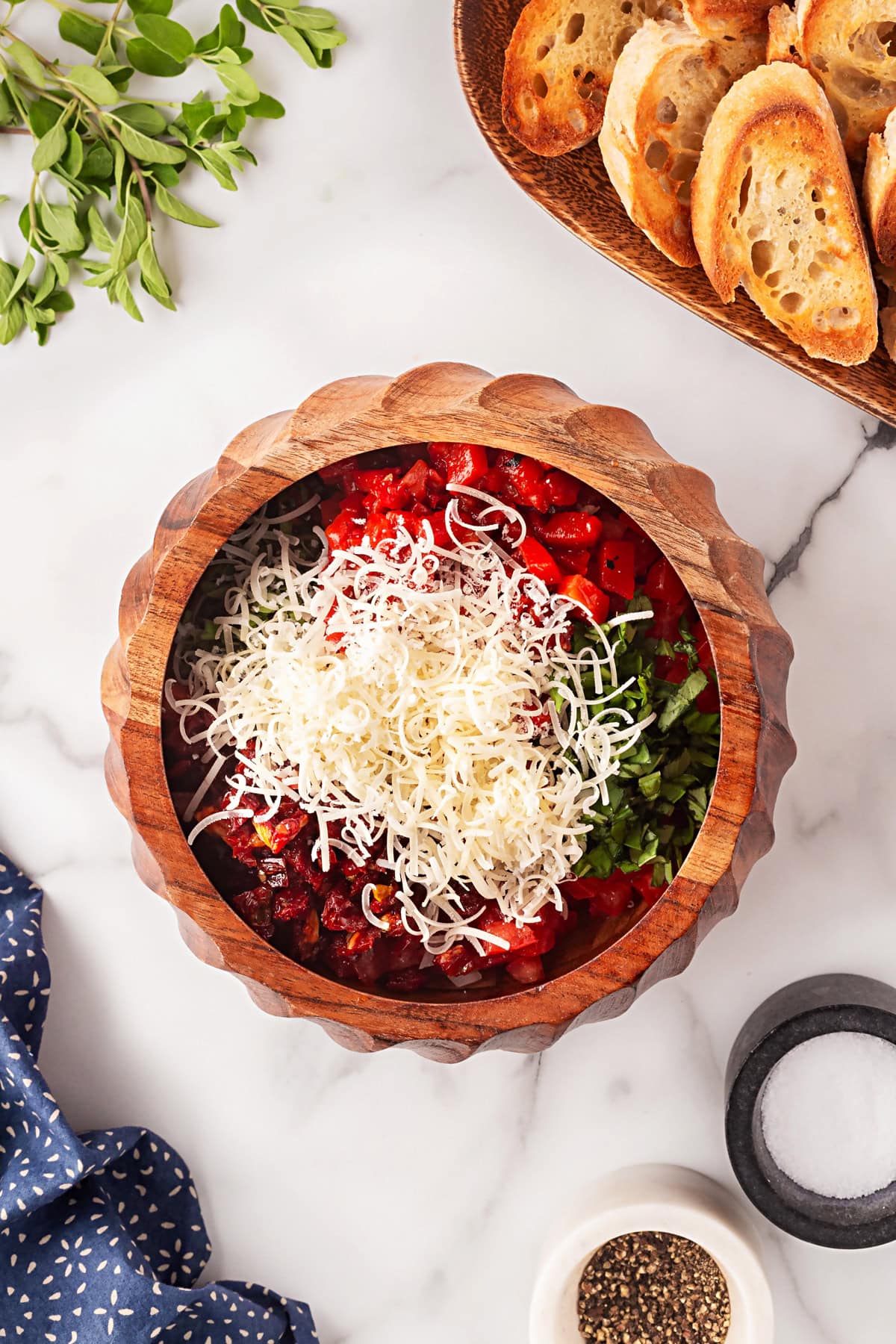 This Best Tomato Bruschetta recipe will have you making it all year round. The flavors are perfectly balanced and one that I get rave reviews from. Cheese added.