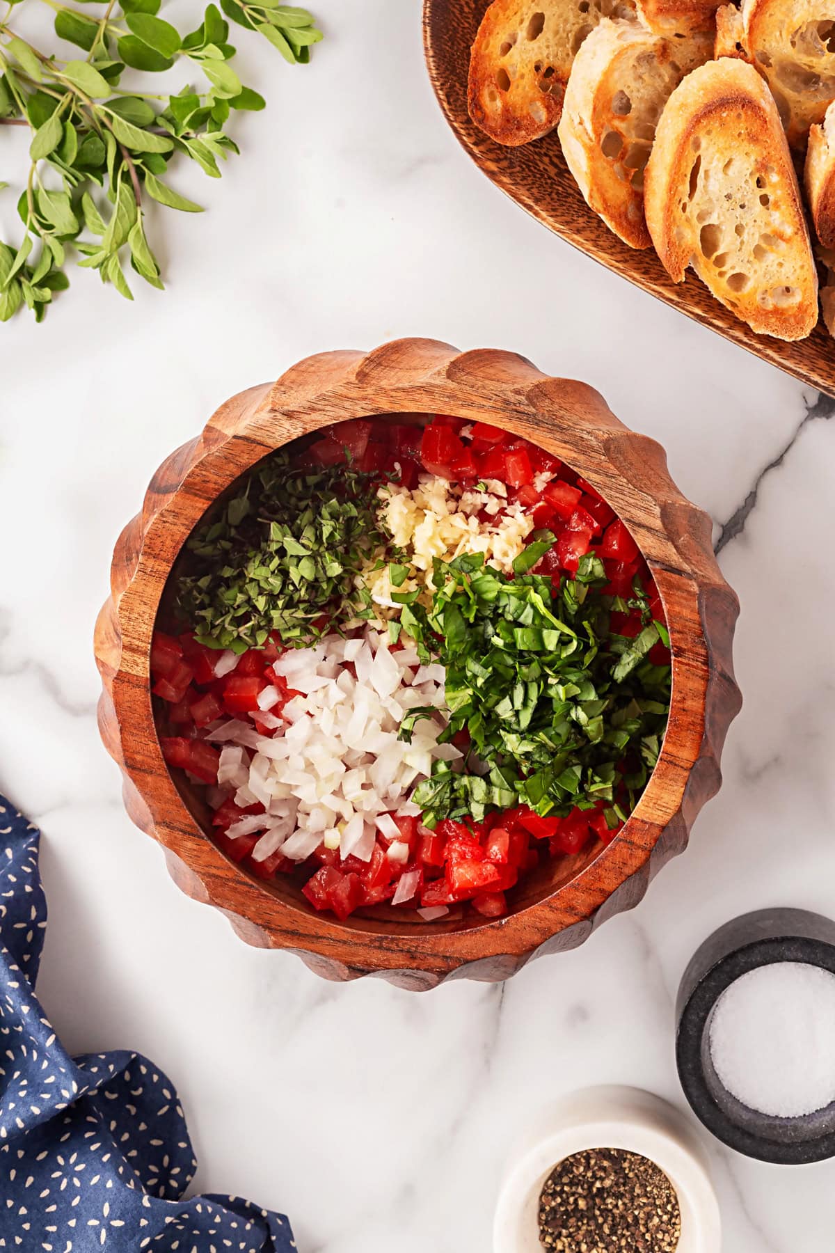 This Best Tomato Bruschetta recipe will have you making it all year round. The flavors are perfectly balanced and one that I get rave reviews from. Herbs added.