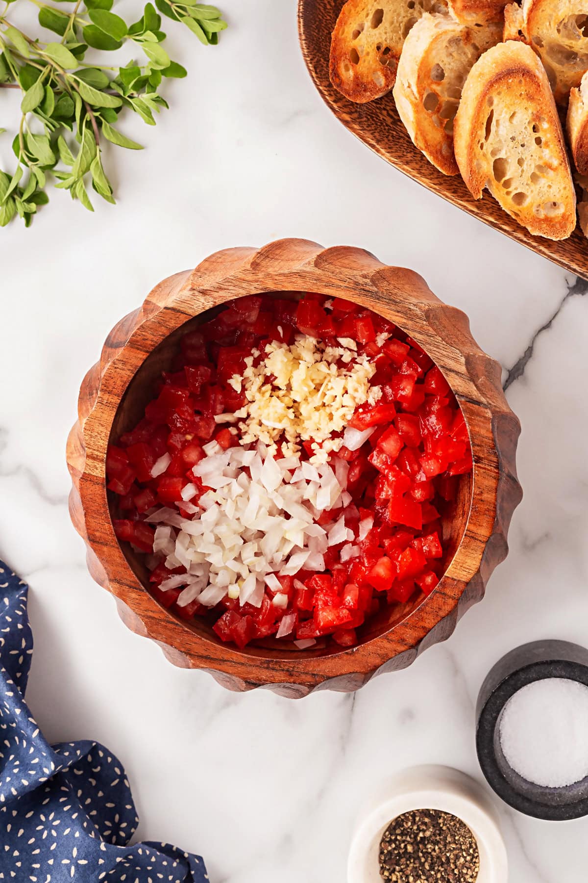 This Best Tomato Bruschetta recipe will have you making it all year round. The flavors are perfectly balanced and one that I get rave reviews from. Onions and garlic added.