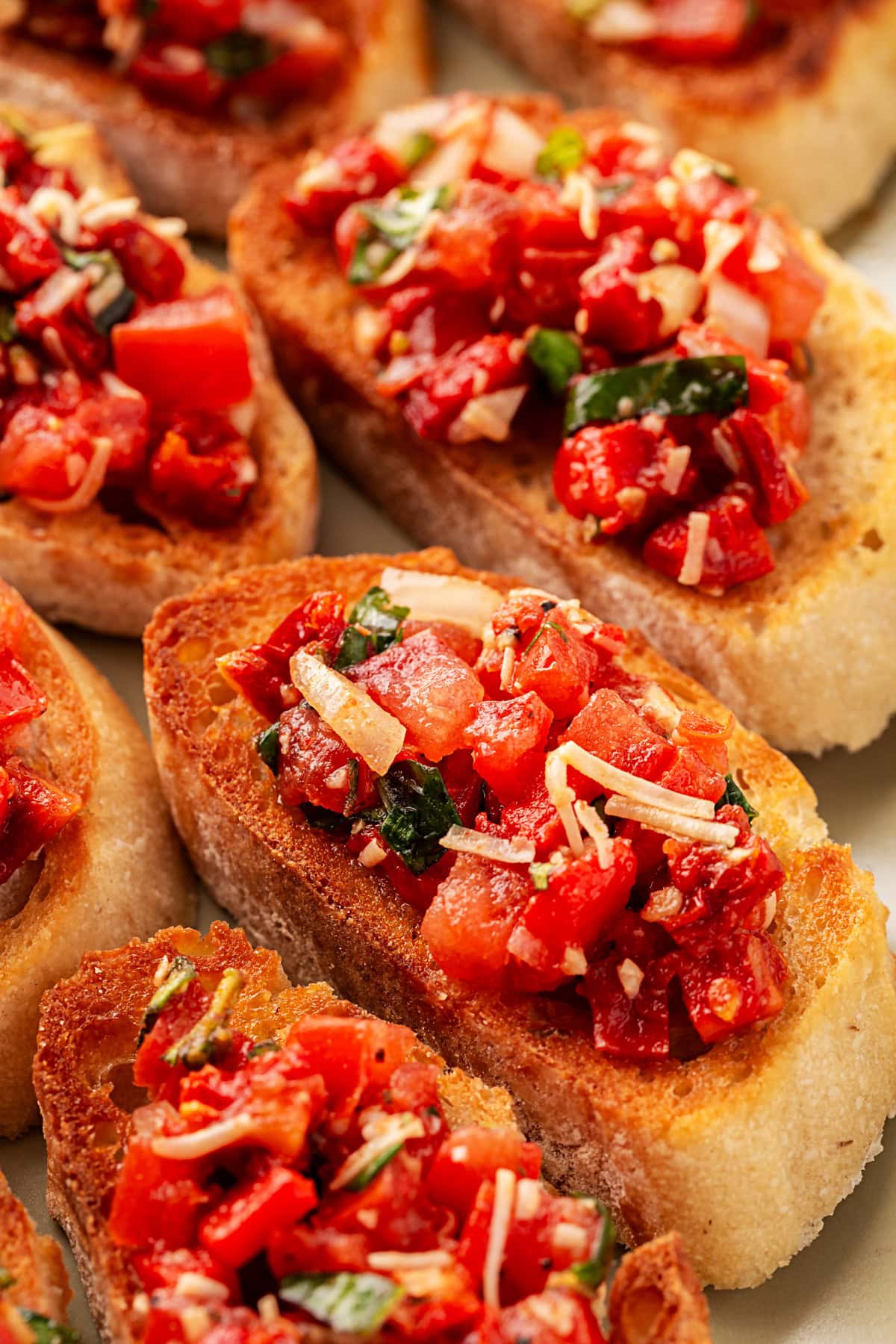 This Best Tomato Bruschetta recipe will have you making it all year round. The flavors are perfectly balanced and one that I get rave reviews from. Close-up of Best Tomato Bruschetta.