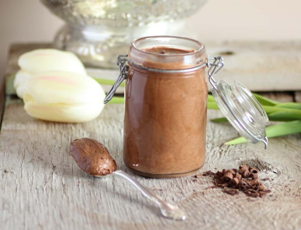 Chocolate Mousse in a glass jar with a lid and spoon full of mousse beside the jar