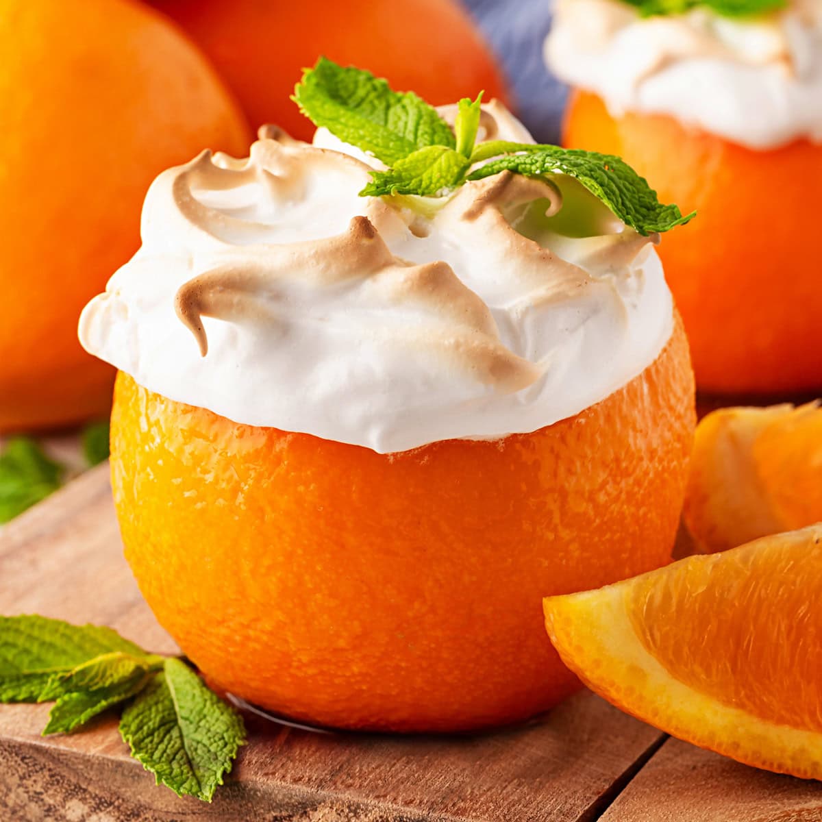 Square photo of an orange baked Alaska. 