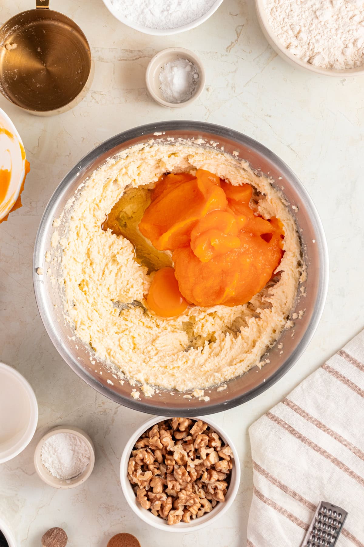 Adding pumpkin puree to the creamy butter.