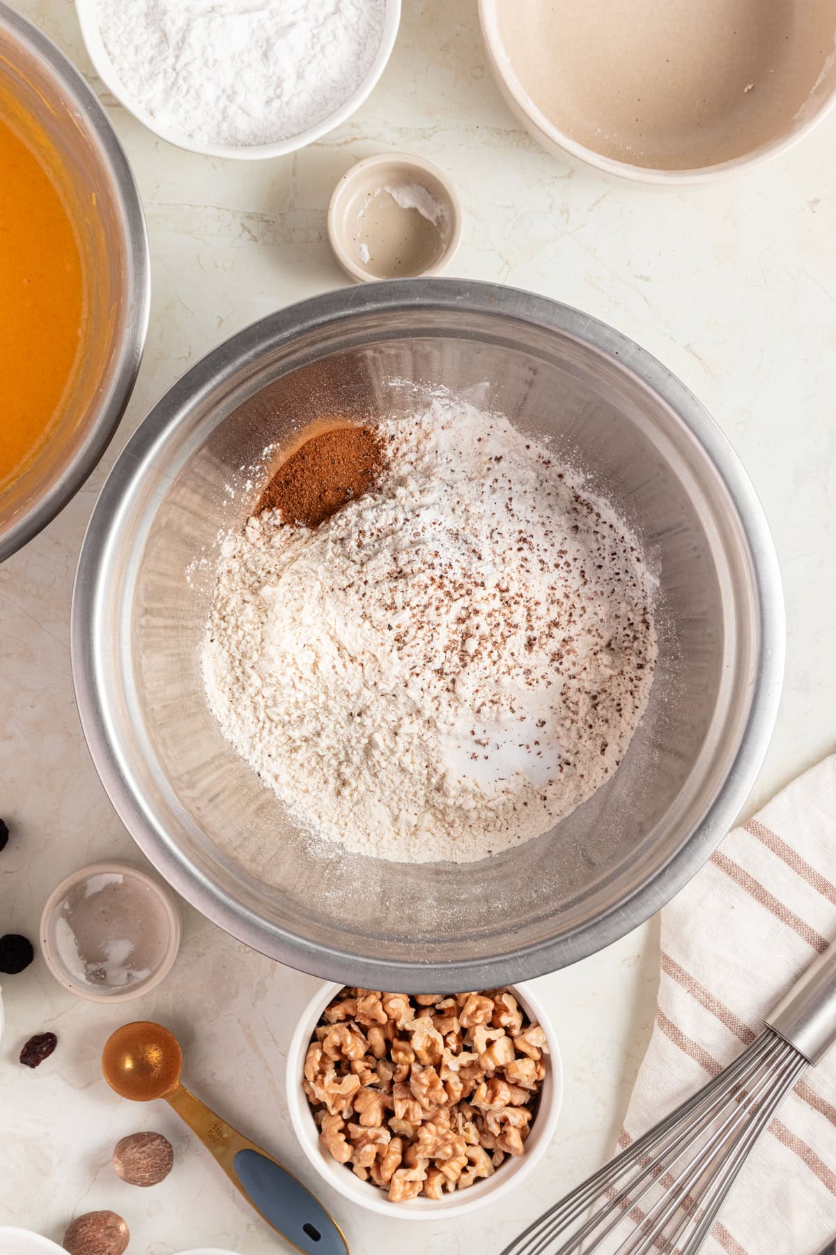 Mixing dry ingredients into a large bowl.