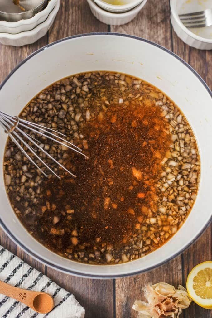 Grill glaze ingredients in a pot with a whisk