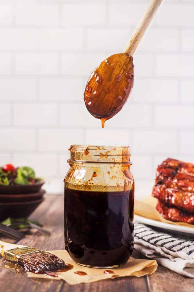 Copycat TGI Fridays Grill Glaze with a wooden spoon coming out of a jar