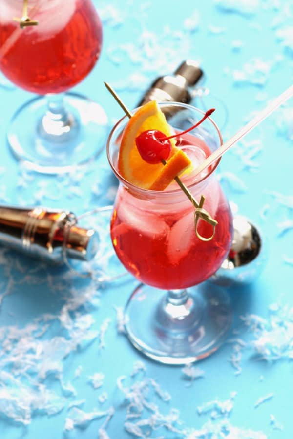 Cherry bomb drink in a glass with a orange slice and a cherry for garnish