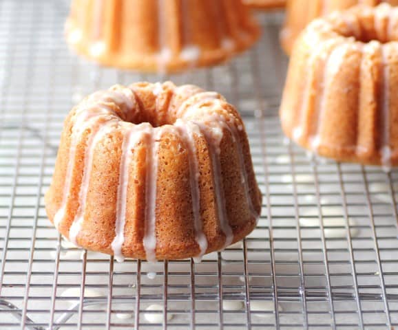 Mini Orange Bundts with a Grand Marnier Glaze on a wire cooling rack