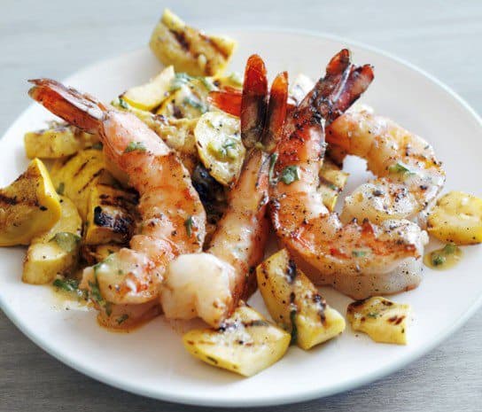 Grilled Shrimp with summer squash on a white plate