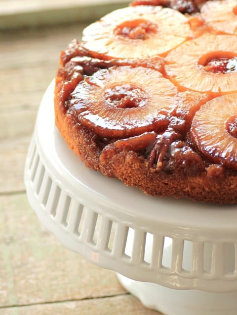 Pineapple Upside Down Cake on a white cake stand. 