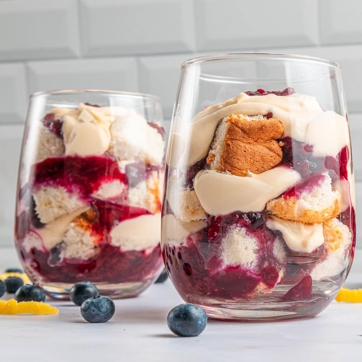 This Blueberry Angel Food Cake Trifle is a masterpiece for the summer, celebrating not only blueberries but also peaches and the flavor of lemon too. It is a winner that you will want to make again. Close-up of the trifle in a glass.