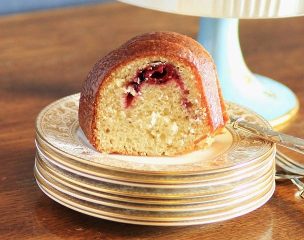 Cherry Kirsch Bundt slice on a white and gold china plate