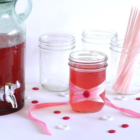 Pretty in Pink Lemonade in a mason jar wrapped in ribbon