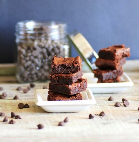 Fudgy Carob Brownies squares stacked on top of each other on a small white plate