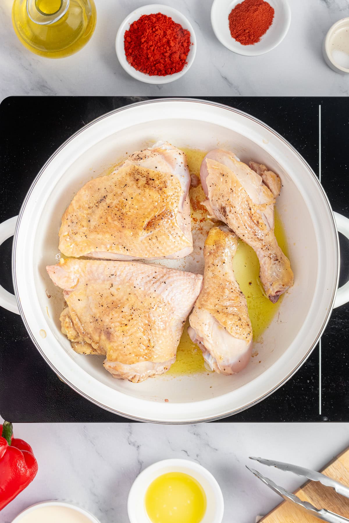 Sear the chicken pieces in a skillet.