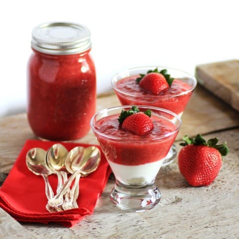 Strawberry Rhubarb Compote in glass serving bowls with a mason jar full in the background