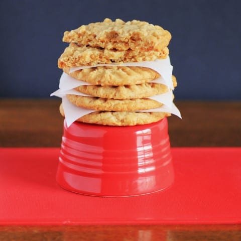 Best Peanut Butter Cookies stack on a a red bowl with paper in between
