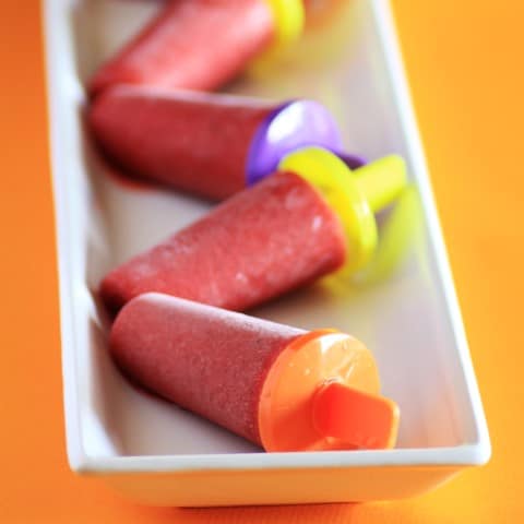 Strawberry Lime Ice Pops  on a white recangle platter