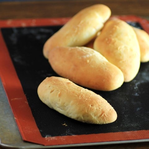 Brioche Hot Dog Buns on a Sipain covered baking sheet