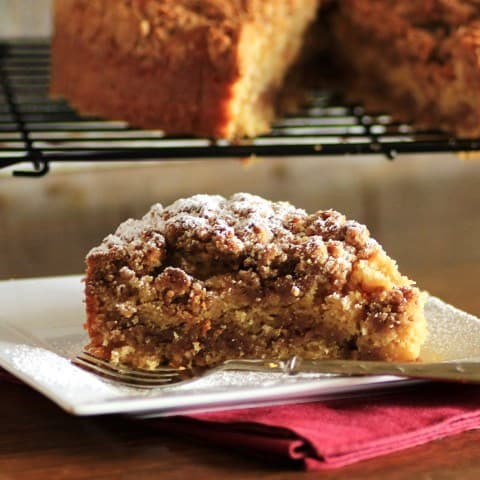 Slice of Maple Syrup Pecan Coffeecake on a White Plate with a fork