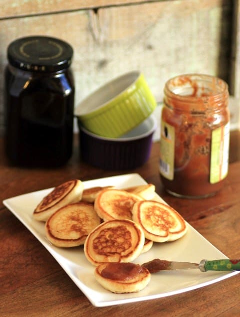 Mini Griddle Cakes on a white plate with apple butter 