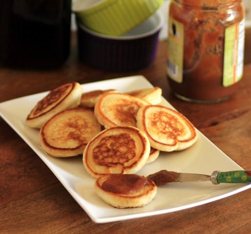 Mini Griddle Cakes on a white plate with apple butter