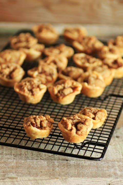 Mini Pumpkin Pies with Spiced Walnut Streusel on a wire cooling rack