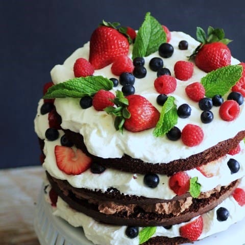 Whipped Cream Berry Layer Cake on a white cake stand