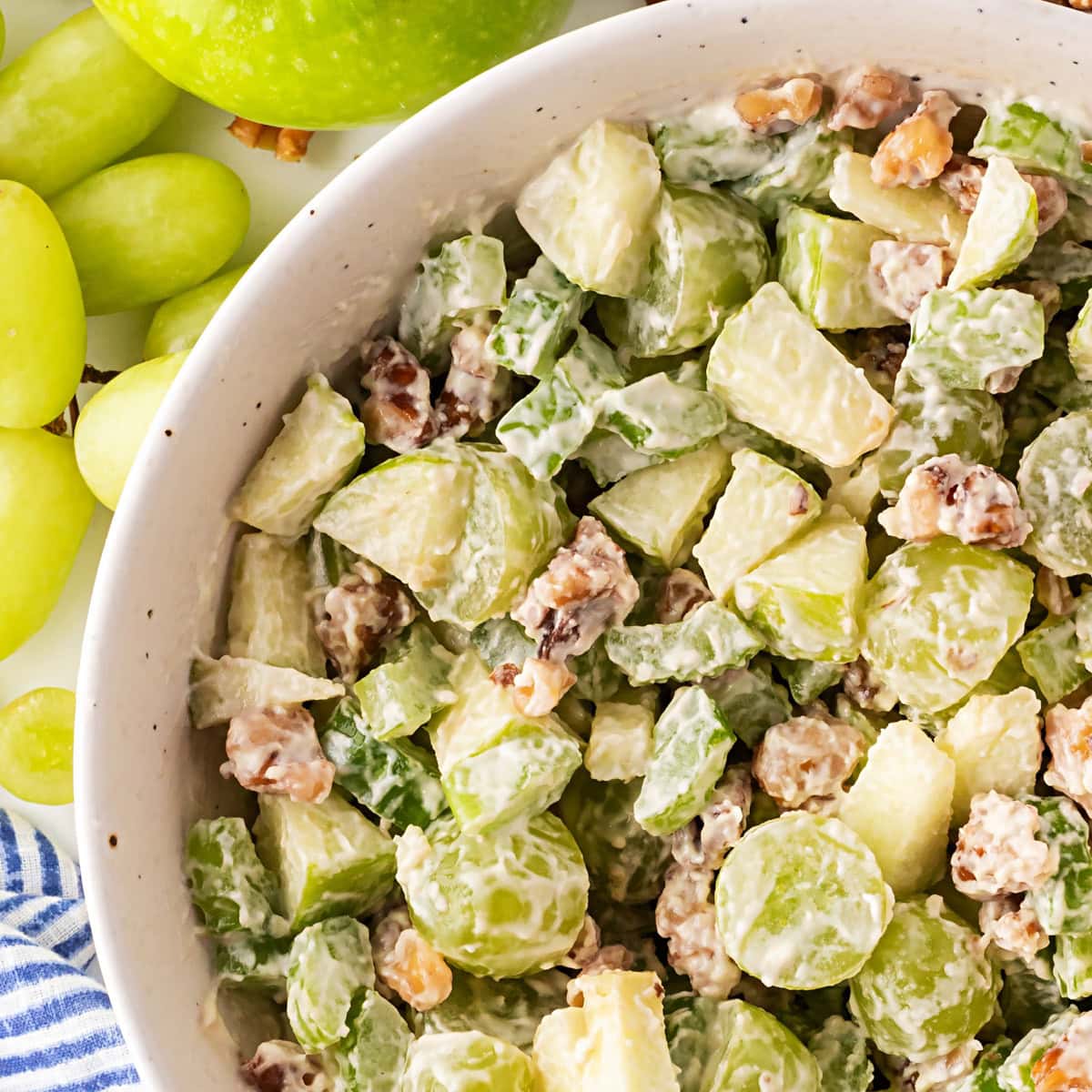 This classic salad has been enjoyed for at least 100 years. Waldorf Salad is simple to make with only 5 main ingredients and 5 minutes of your time. It is a favorite of mine for lunch. Waldorf Salad overhead in a bowl.