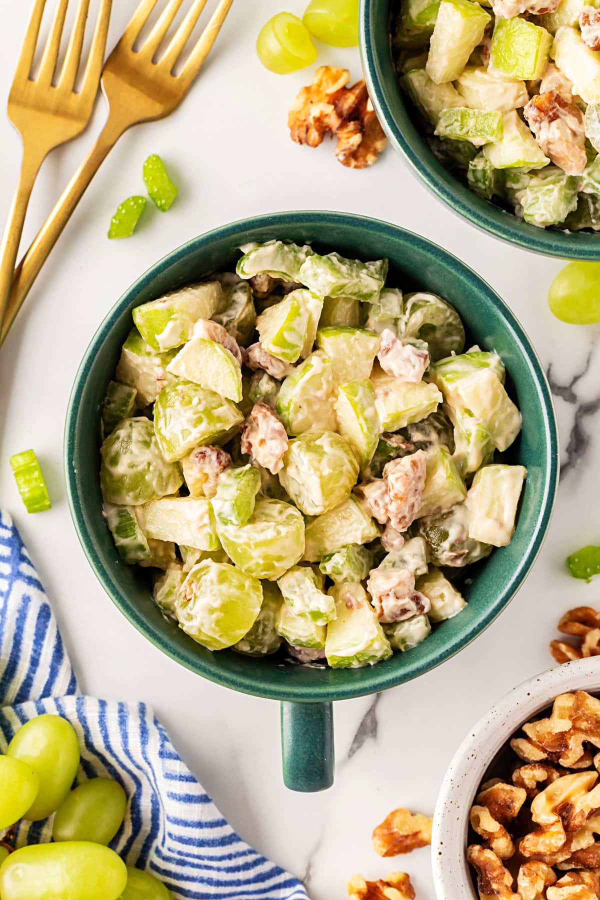 This classic salad has been enjoyed for at least 100 years. Waldorf Salad is simple to make with only 5 main ingredients and 5 minutes of your time. It is a favorite of mine for lunch. Overhead in a small bowl.