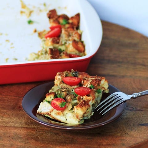 Gluten Free Savory Bread Pudding served on a small brown plate with a fork