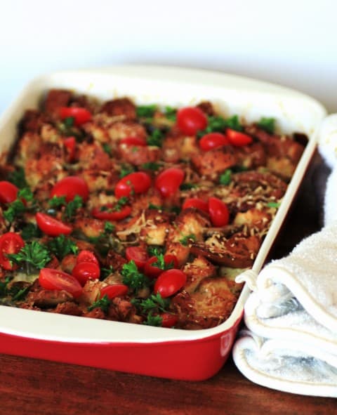 Gluten Free Savory Bread Pudding in a red and white casserole dish 