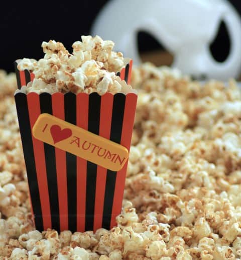 Pumpkin Spice Kettle Corn in piles up and in a small black and orange I Heart Autumn paper container