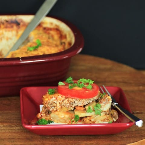 Shipwreck serving on a square red plate with a fork beside it.