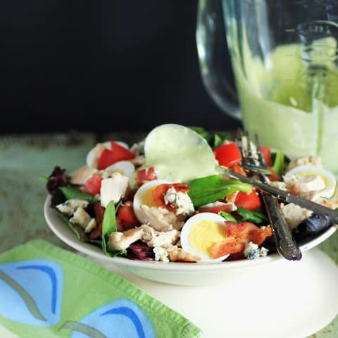 Wendy's Chicken BLT Cobb Salad in a white bowl with a fork and green cloth napkin