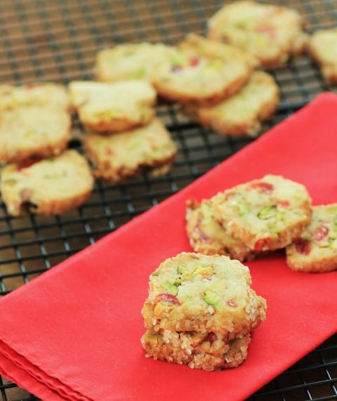 Cherry Pistachio Ice Box Cookies on a red napkin on a cooling rack