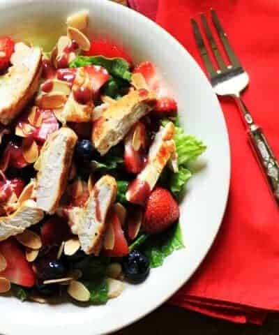 Wendy's copycat berry almond chicken salad on a white plate with a fork and red napkin