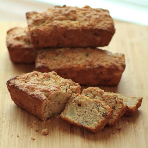 Apple Pecan Buttermilk Bread mini loaves stacked on a wooden cutting board