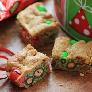 Holiday Cookie Bars cut and sitting on a wooden board