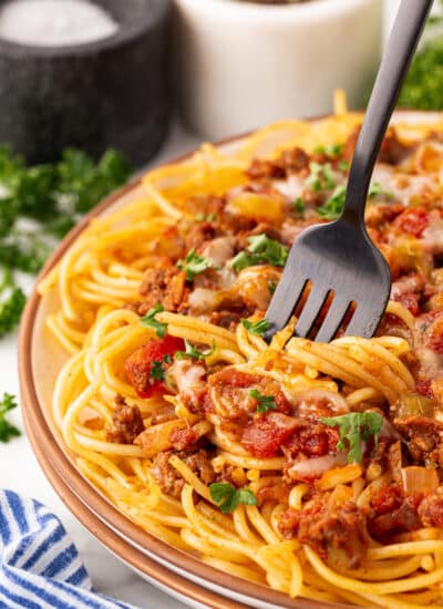 Mexican Spaghetti on a plate with a fork being twirled in.