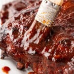 Brushing ribs with extra sauce.