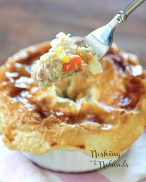 Individual chicken pot pie with a fork full taken out ready to eat