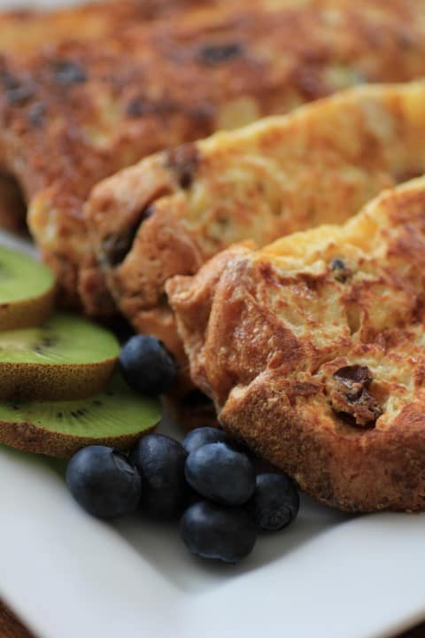 Panettone French Toast served on a white plate with kiwi slices and blueberries