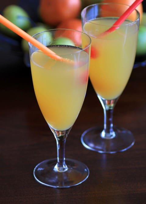 Peach Sparkler drinks in tall stem glasses with straws