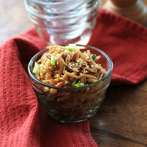 Sesame Orzo in a small glass bowl on a red napkin