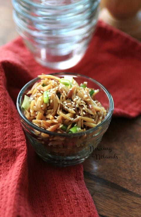 Sesame Orzo in a small glass bowl on a red napkin